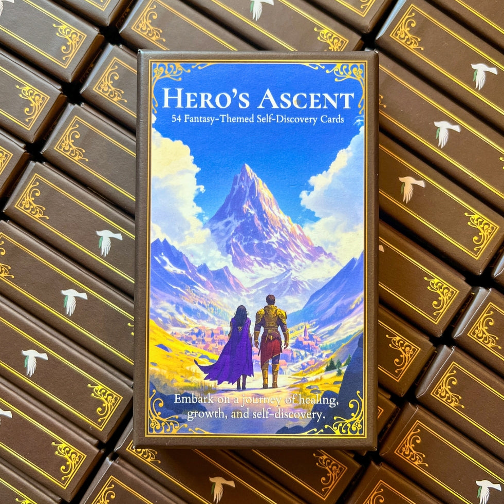 Oracle card box titled 'Hero's Ascent' with a mountain and two characters on the cover, surrounded by more card boxes.